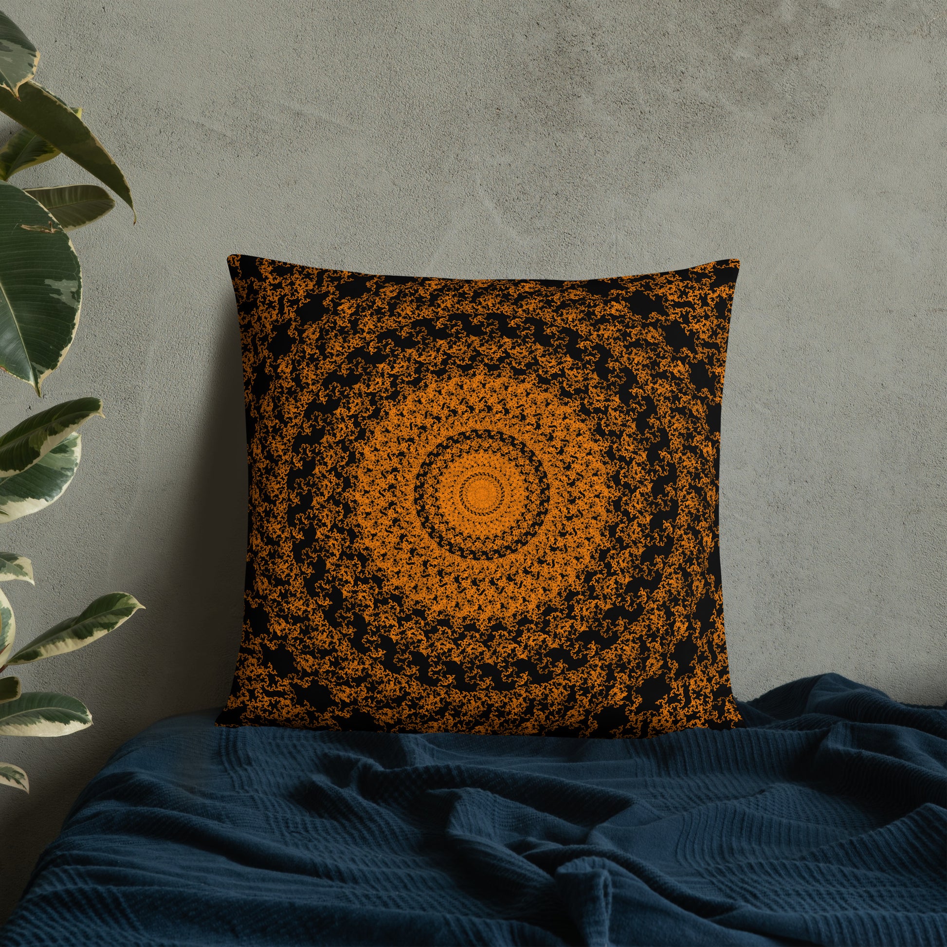22″×22″ throw pillow with the 'The Sun' orange and black geometric design on a bed.