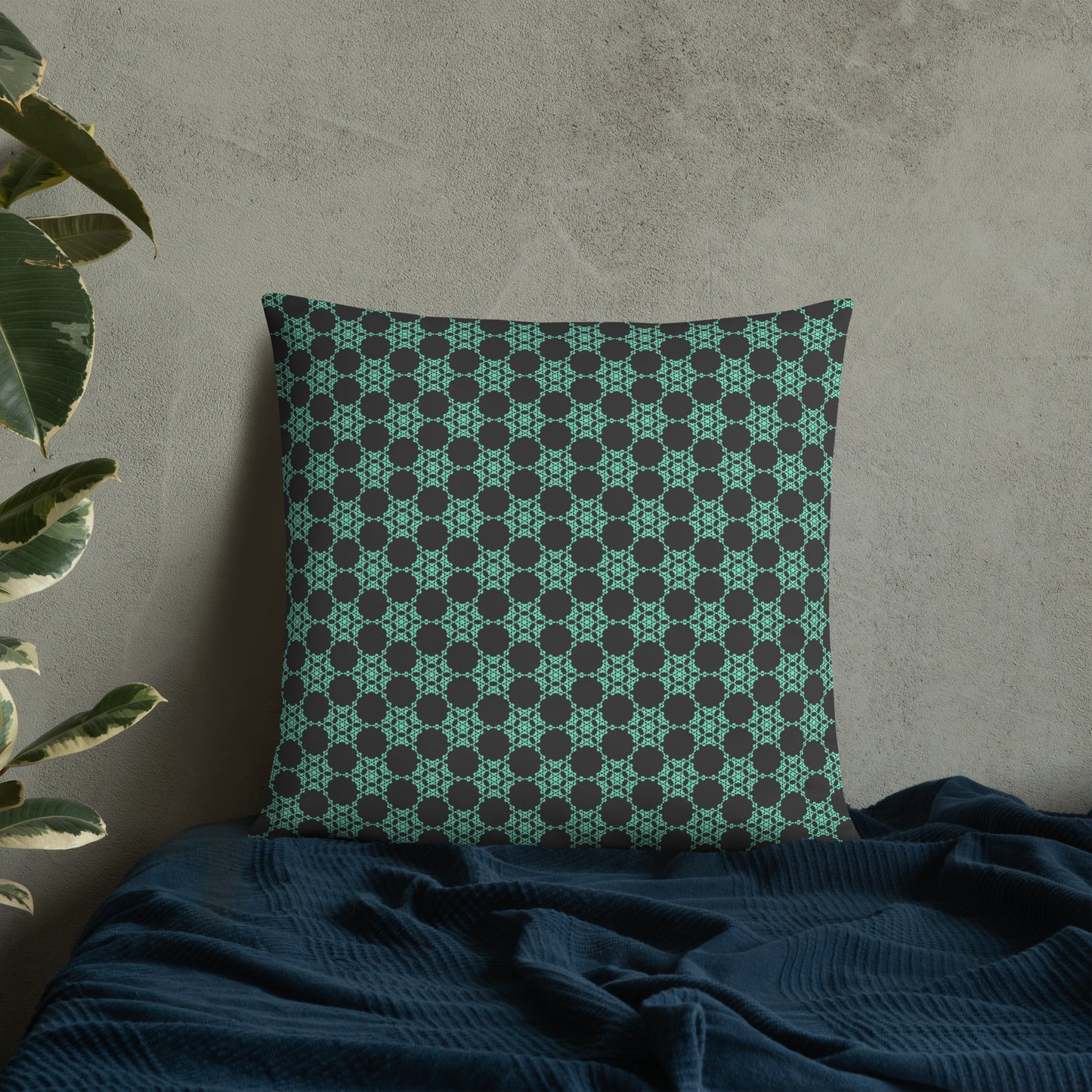 22″×22″ throw pillow with the 'Flowers Victory' charcoal and mint geometric pattern on a bed.