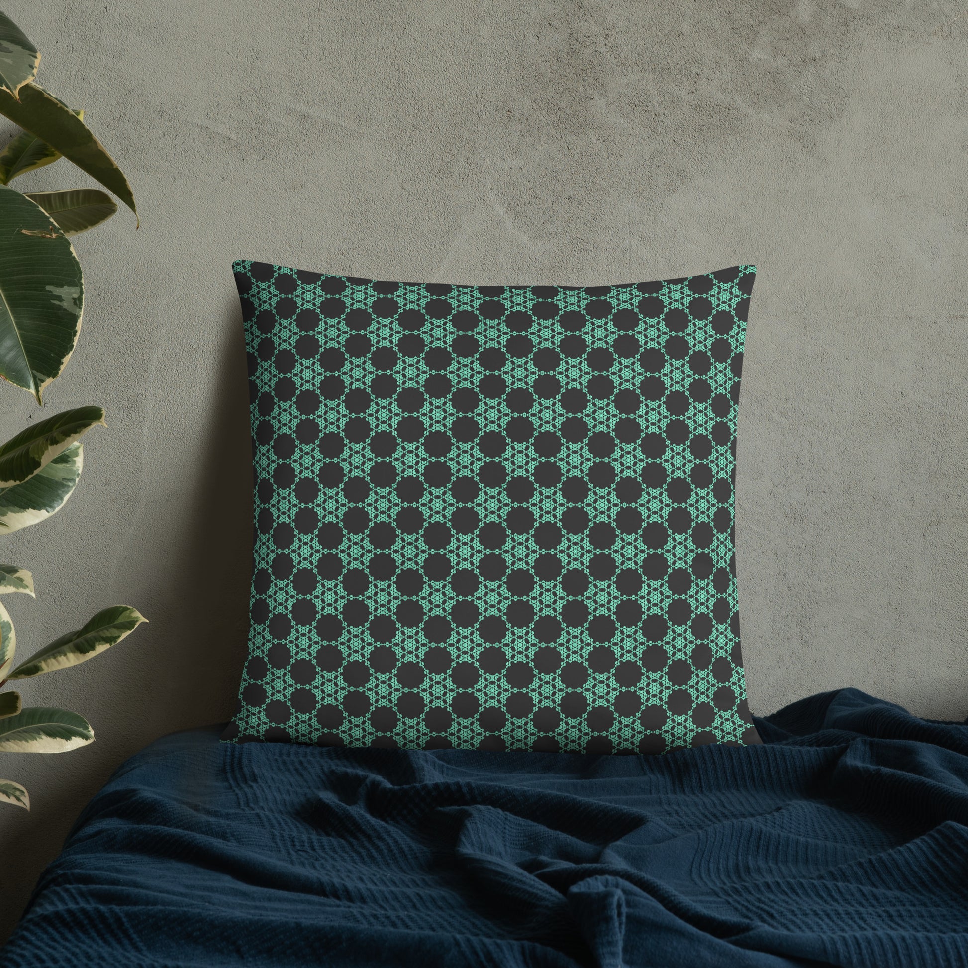 22″×22″ throw pillow with the 'Flowers Victory' charcoal and mint geometric pattern on a bed.