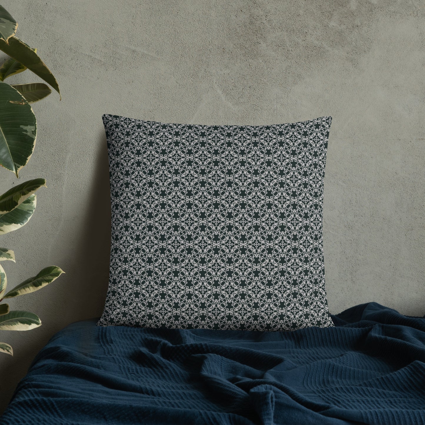 22″×22″ throw pillow with the 'Tetragon' charcoal and white geometric pattern on a bed.