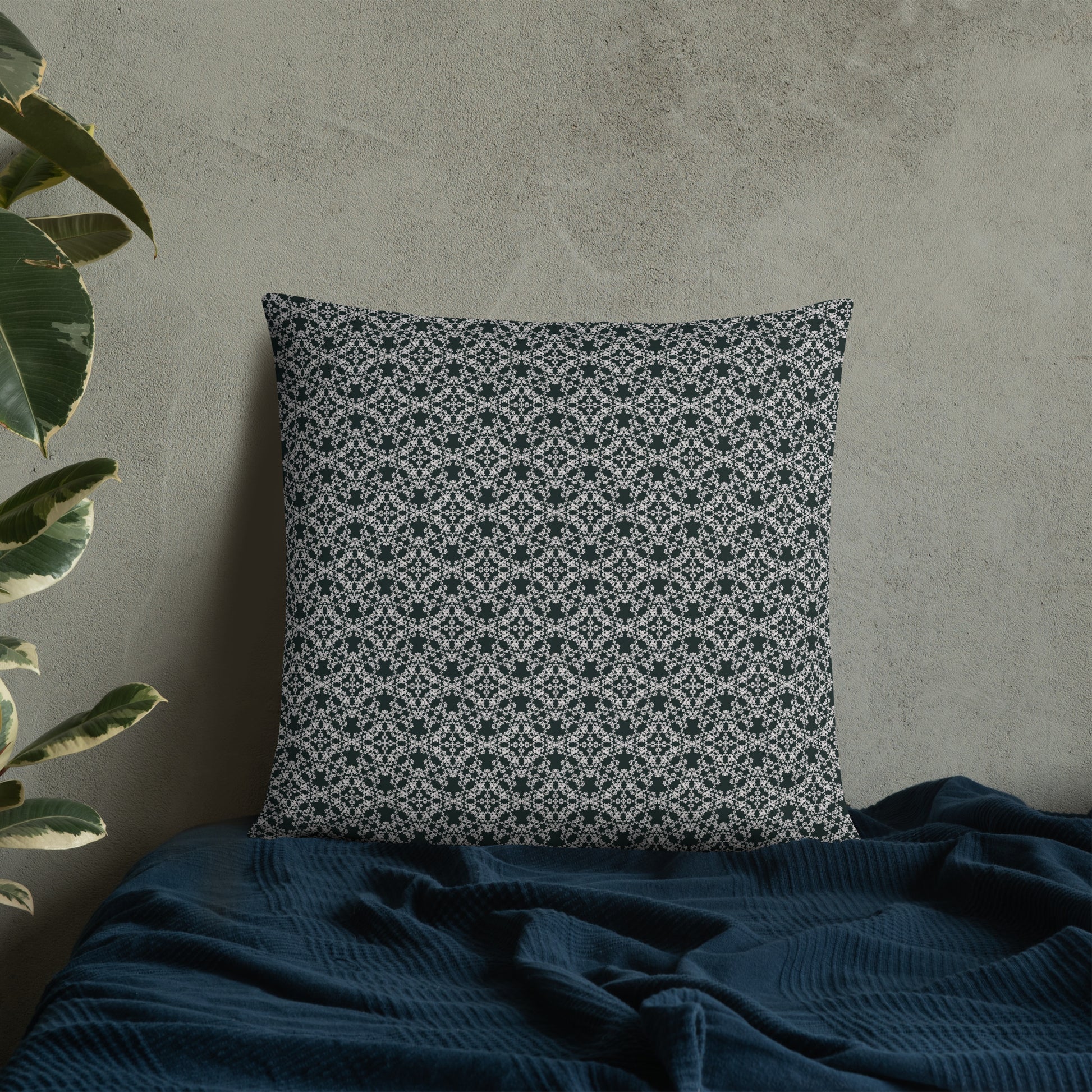 22″×22″ throw pillow with the 'Tetragon' charcoal and white geometric pattern on a bed.