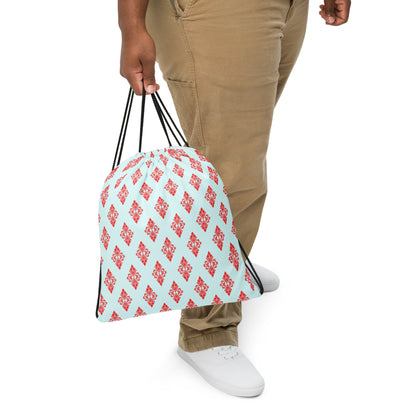 Close up of a person slinging the drawstring bag with the 'Digon' sky blue and red fractal geometric design.