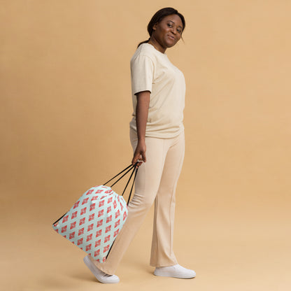 Woman slinging the drawstring bag with the 'Digon' sky blue and red fractal geometric pattern.