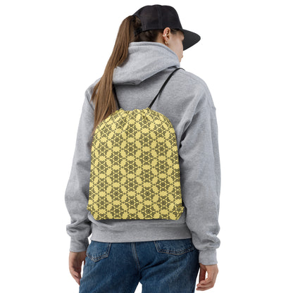 Back shot of a young woman wearing the drawstring bag with the 'Hexagon' yellow and black fractal geometric pattern.