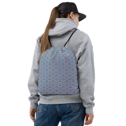 Back shot of a young woman wearing the drawstring bag with the 'Quadragon' charcoal and white fractal geometric pattern.