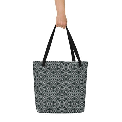 Hand holding the large tote bag with the 'Quadragon' charcoal and white fractal geometric pattern.
