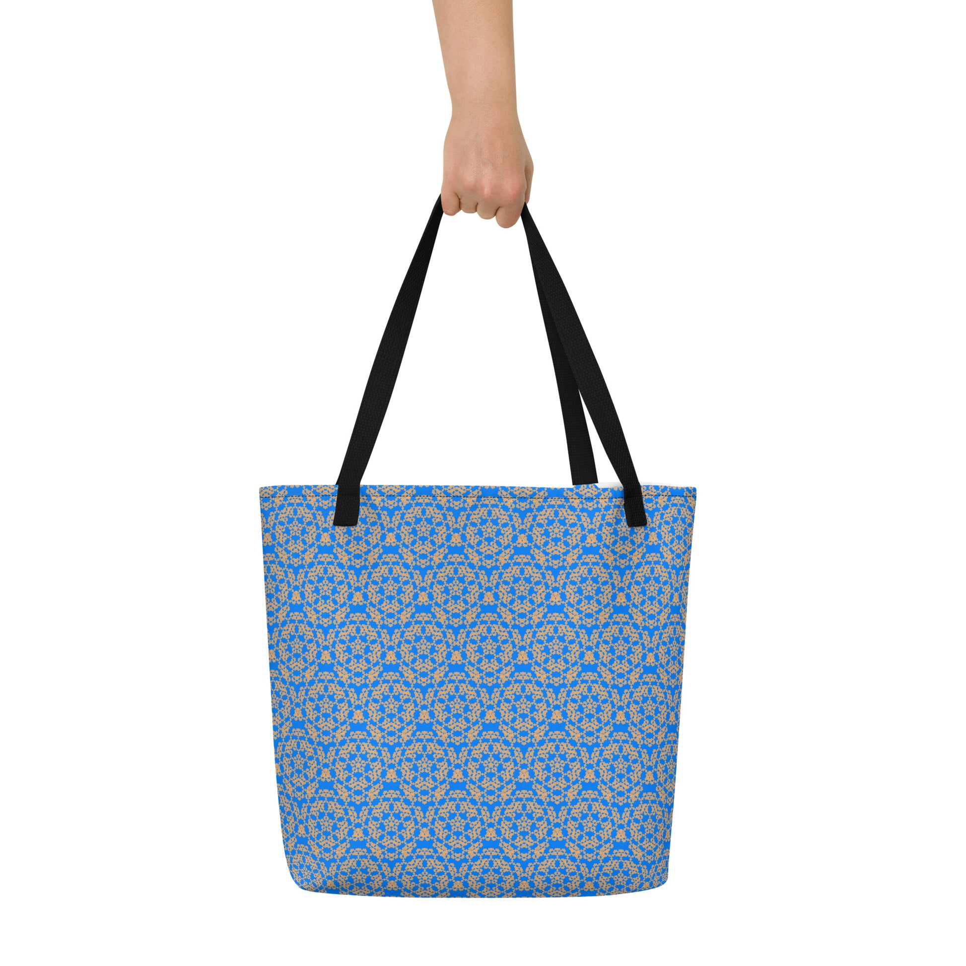Hand holding the large tote bag with the 'Pentagon' blue and yellow fractal geometric pattern.