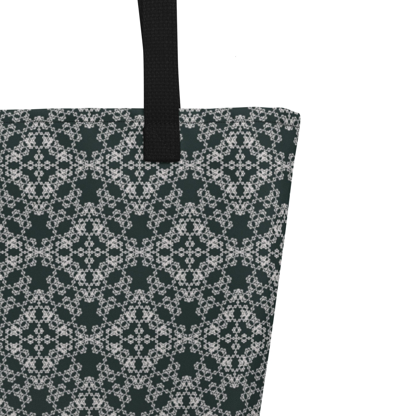 Close up of the strap stitching of the large tote bag with the 'Quadragon' charcoal and white fractal geometric pattern.