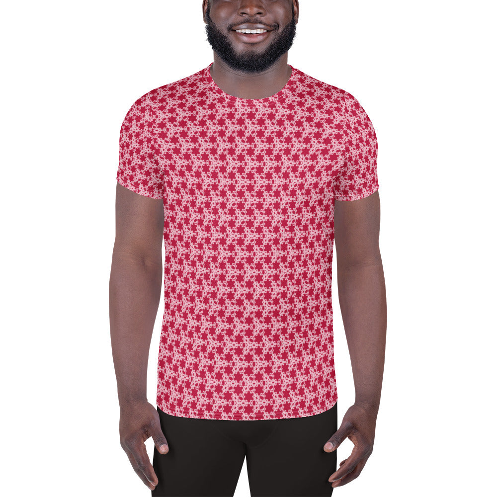 Front shot of a model wearing the men's athletic t-shirt with the 'Trigon' red and pink fractal geometric pattern.