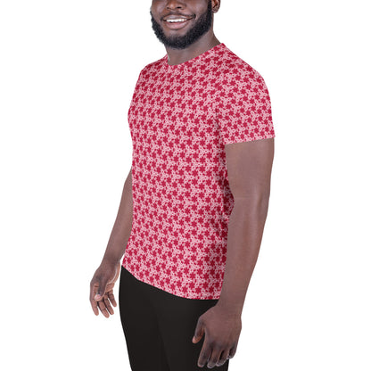 Left front shot of a model wearing the men's athletic t-shirt with the 'Trigon' red and pink fractal geometric pattern.