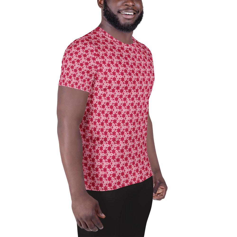 Right front shot of a model wearing the men's athletic t-shirt with the 'Trigon' red and pink fractal geometric pattern.