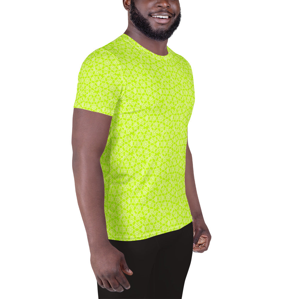 Right front shot of a model wearing the men's athletic t-shirt with the 'Heptagon' yellow-green fractal geometric pattern.