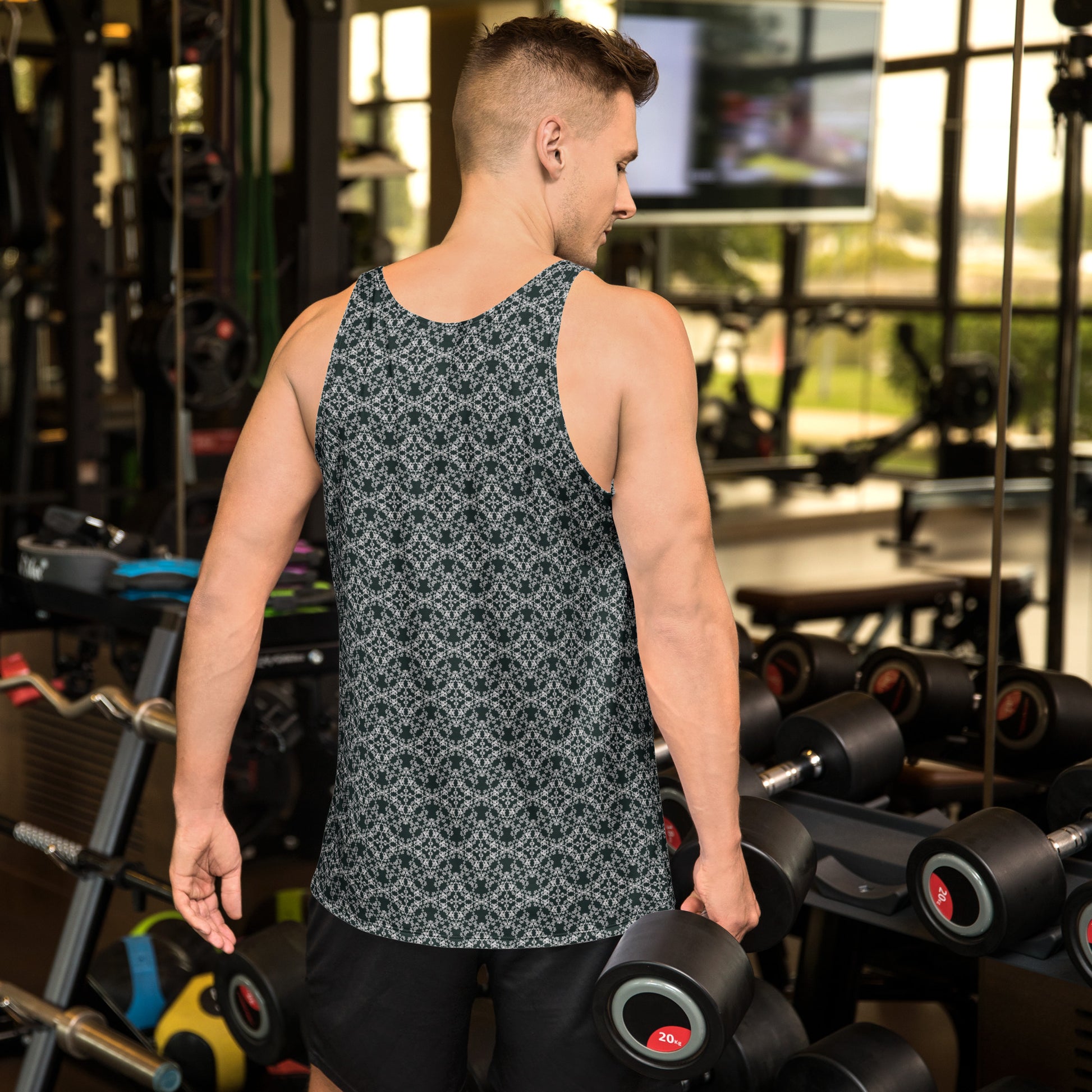 Back shot of a young man training in the gym, wearing the tank top with the 'Quadragon' charcoal and white fractal geometric pattern.