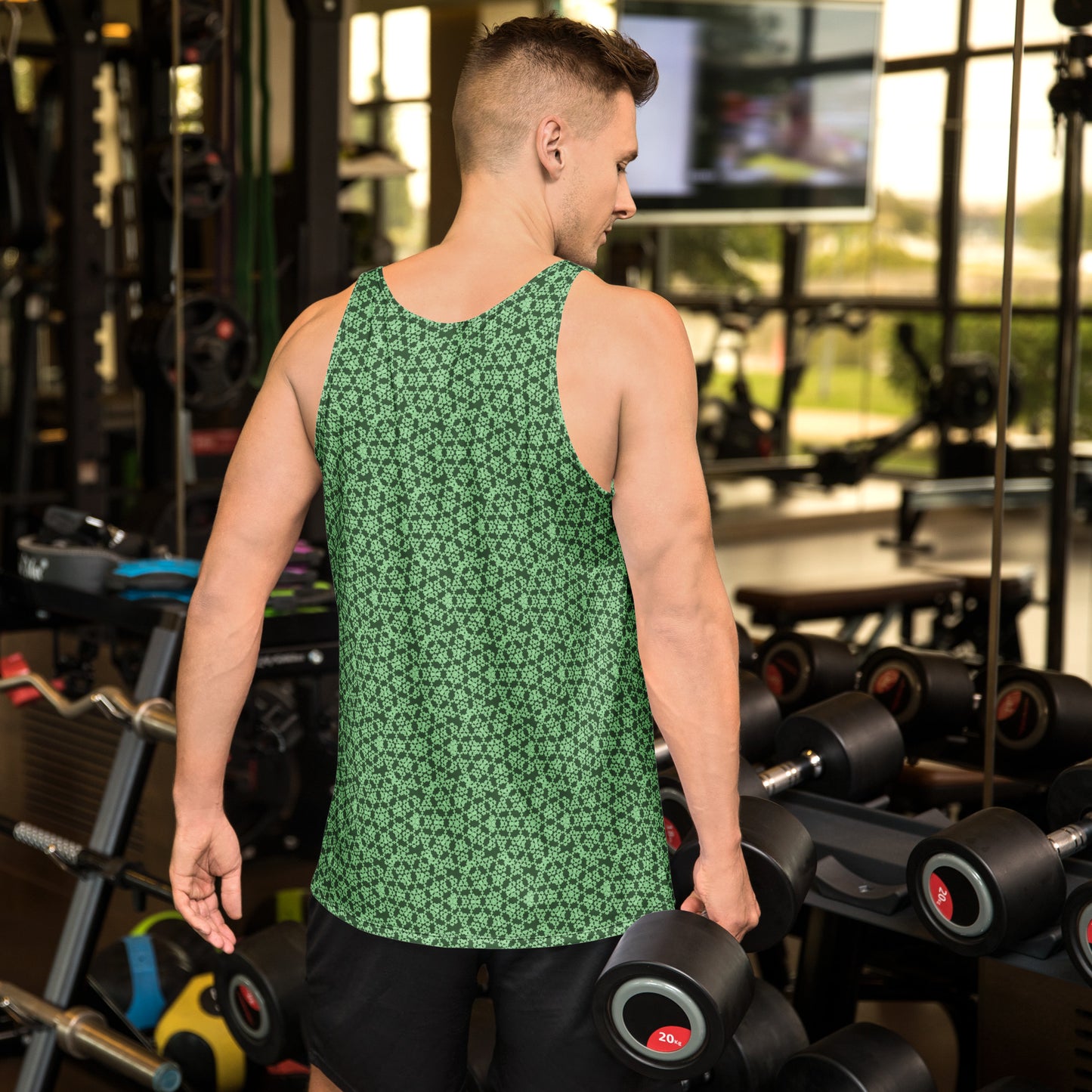 Back shot of a young man training in the gym, wearing the tank top with the 'Heptagon' green fractal geometric pattern.