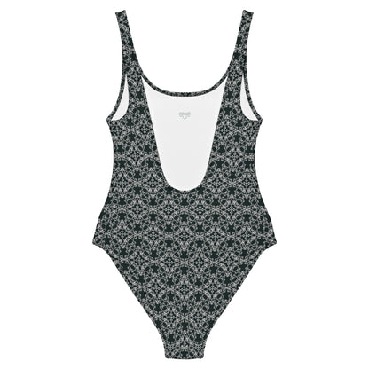 Back of the one-piece swimsuit with the 'Quadragon' charcoal and white fractal geometric pattern.