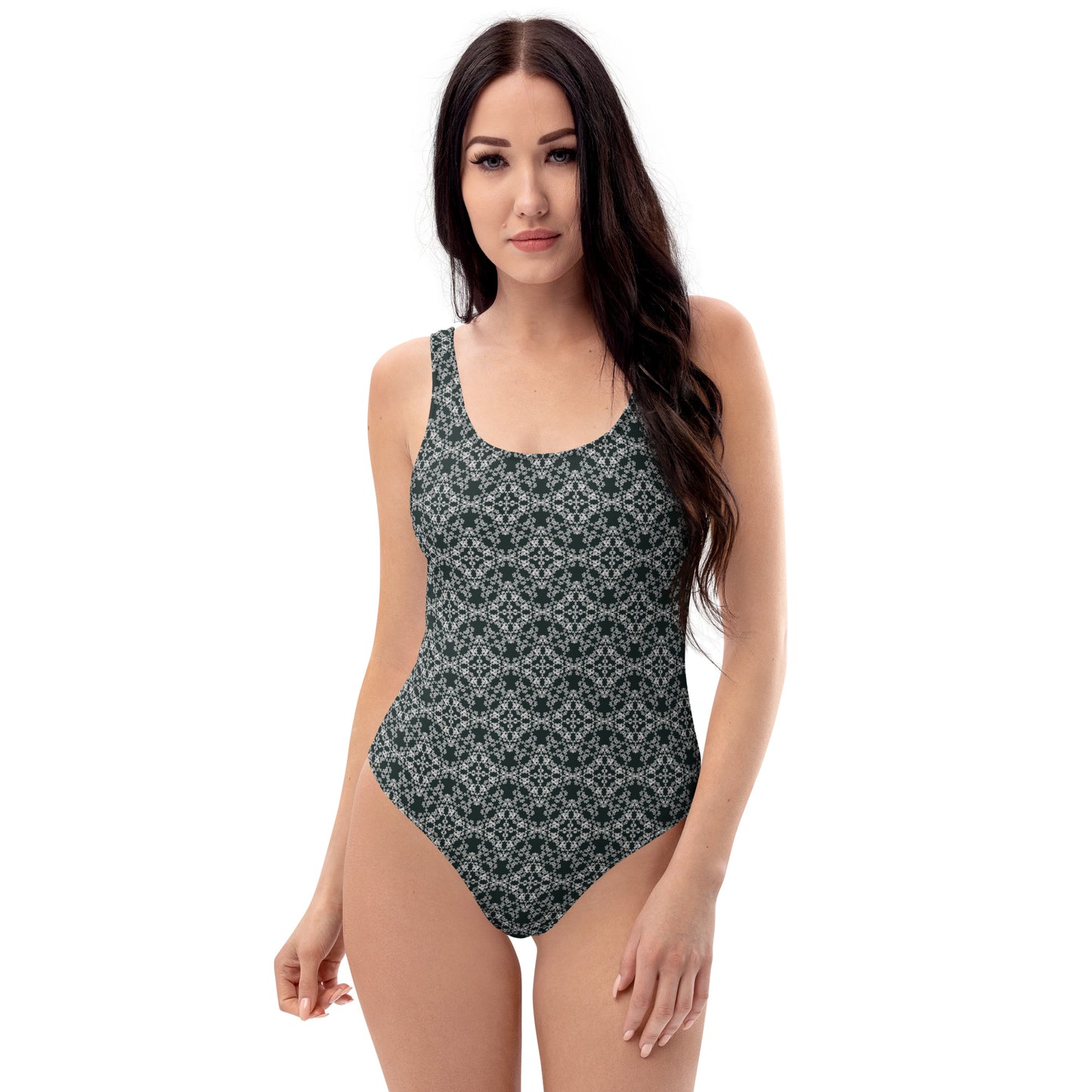 Front shot of a model wearing the one-piece swimsuit with the 'Quadragon' charcoal and white fractal geometric pattern.