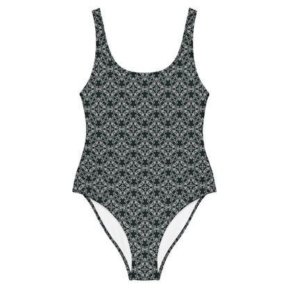 Front of the one-piece swimsuit with the 'Quadragon' charcoal and white fractal geometric pattern.