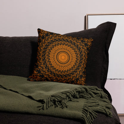 18″×18″ premium throw pillow with the 'The Sun' orange and black geometric design on a couch.