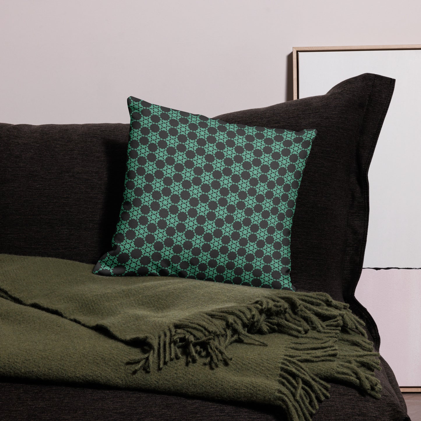 18″×18″ premium throw pillow with the 'Flowers Victory' charcoal and mint geometric pattern on a couch.