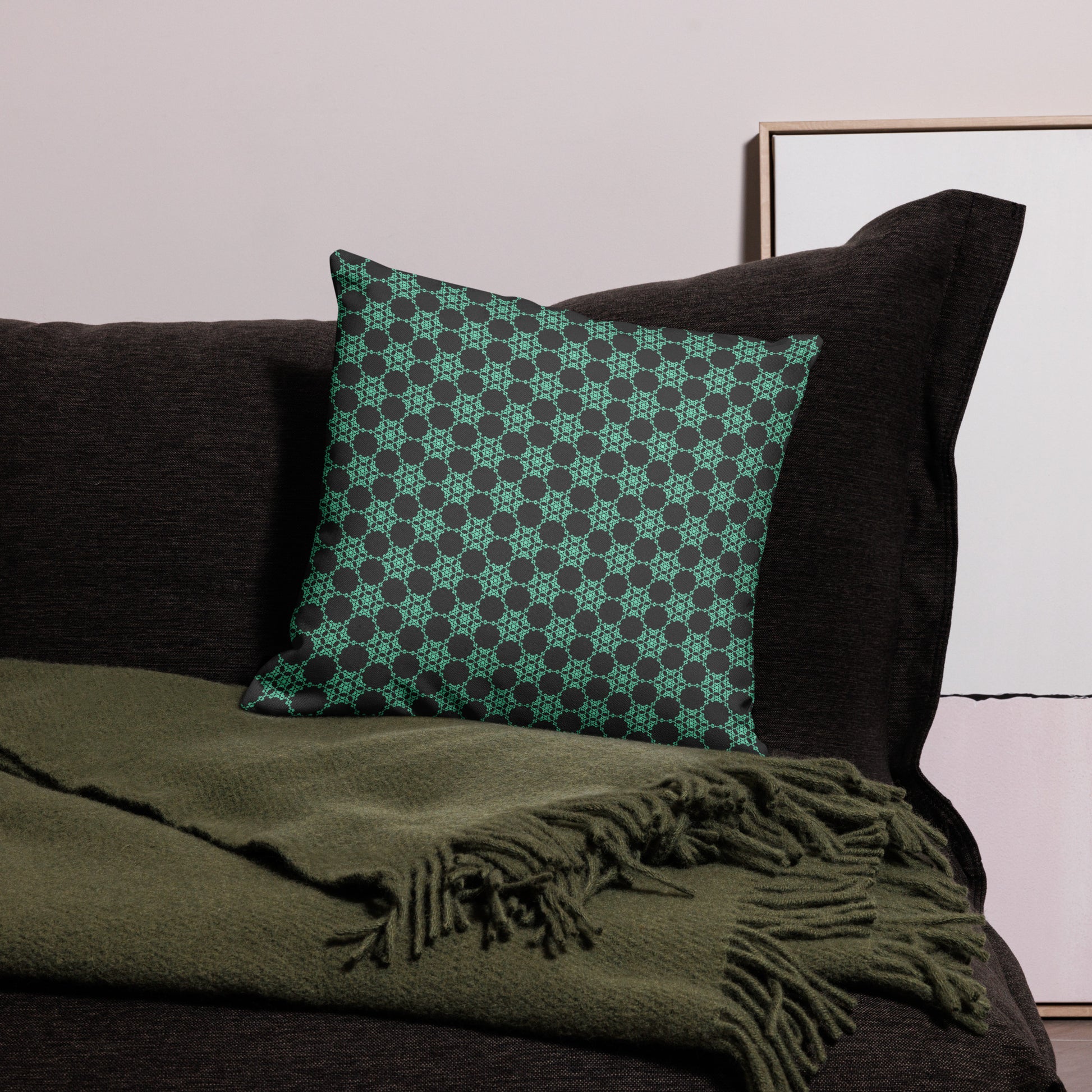 18″×18″ premium throw pillow with the 'Flowers Victory' charcoal and mint geometric pattern on a couch.