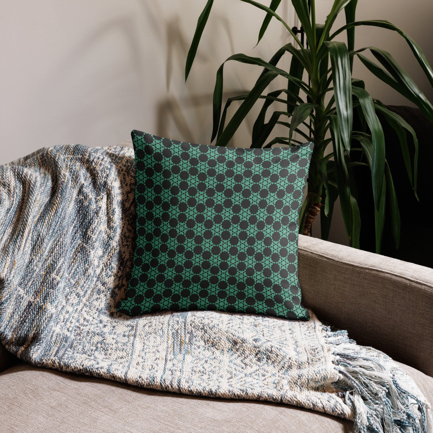18″×18″ premium throw pillow with the 'Flowers Victory' charcoal and mint geometric pattern on a couch.