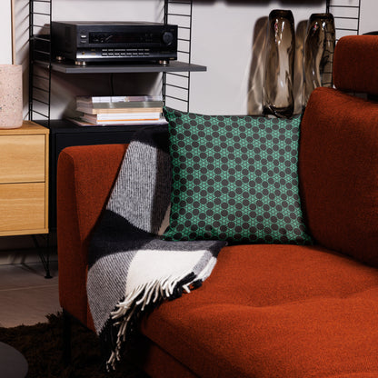 18″×18″ premium throw pillow with the 'Flowers Victory' charcoal and mint geometric pattern on a couch.