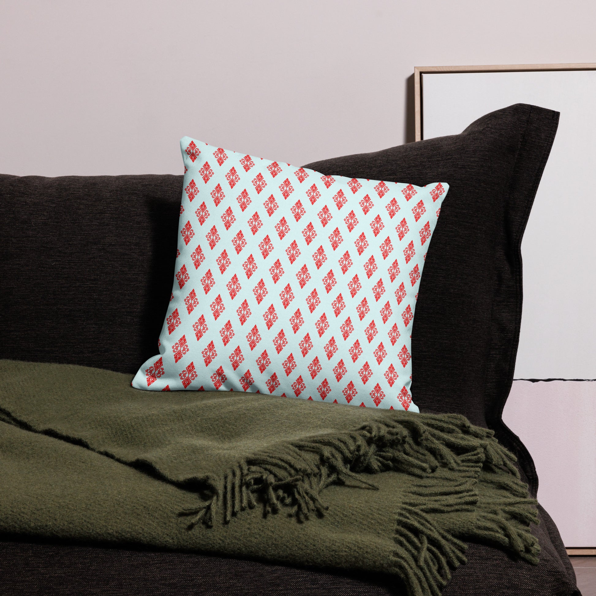 18″×18″ premium throw pillow with the 'Digon' sky blue and red geometric pattern on a couch.