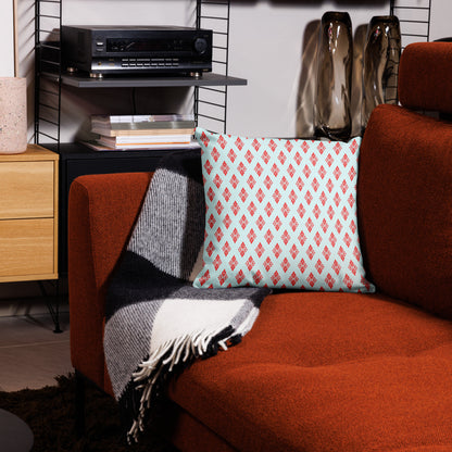 18″×18″ premium throw pillow with the 'Digon' sky blue and red geometric pattern on a couch.