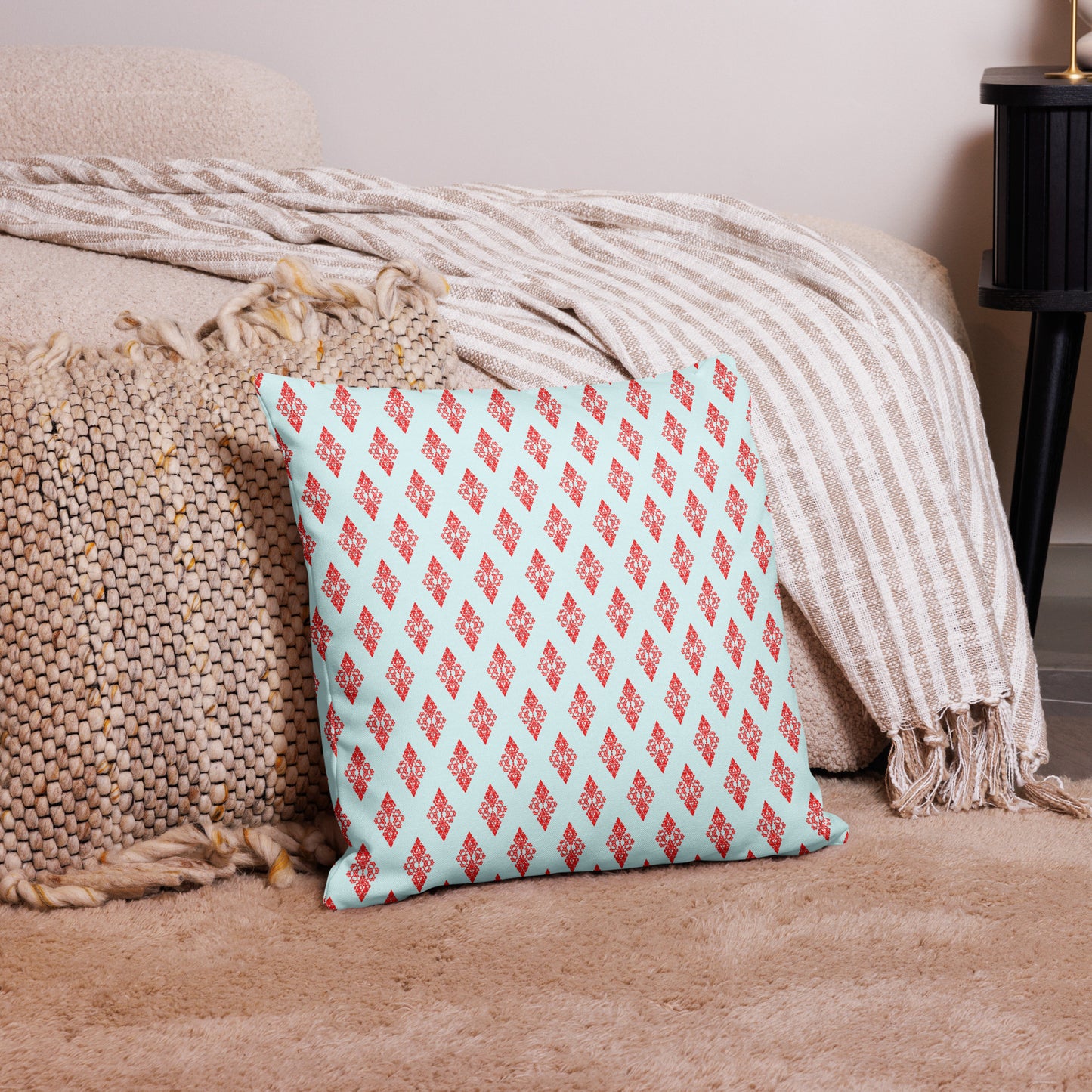 18″×18″ premium throw pillow with the 'Digon' sky blue and red geometric pattern on a couch.