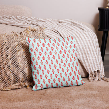 18″×18″ premium throw pillow with the 'Digon' sky blue and red geometric pattern on a couch.