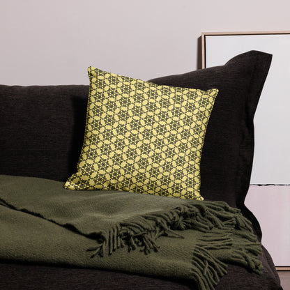 18″×18″ premium throw pillow with the 'Hexagon' yellow and black geometric pattern on a couch.