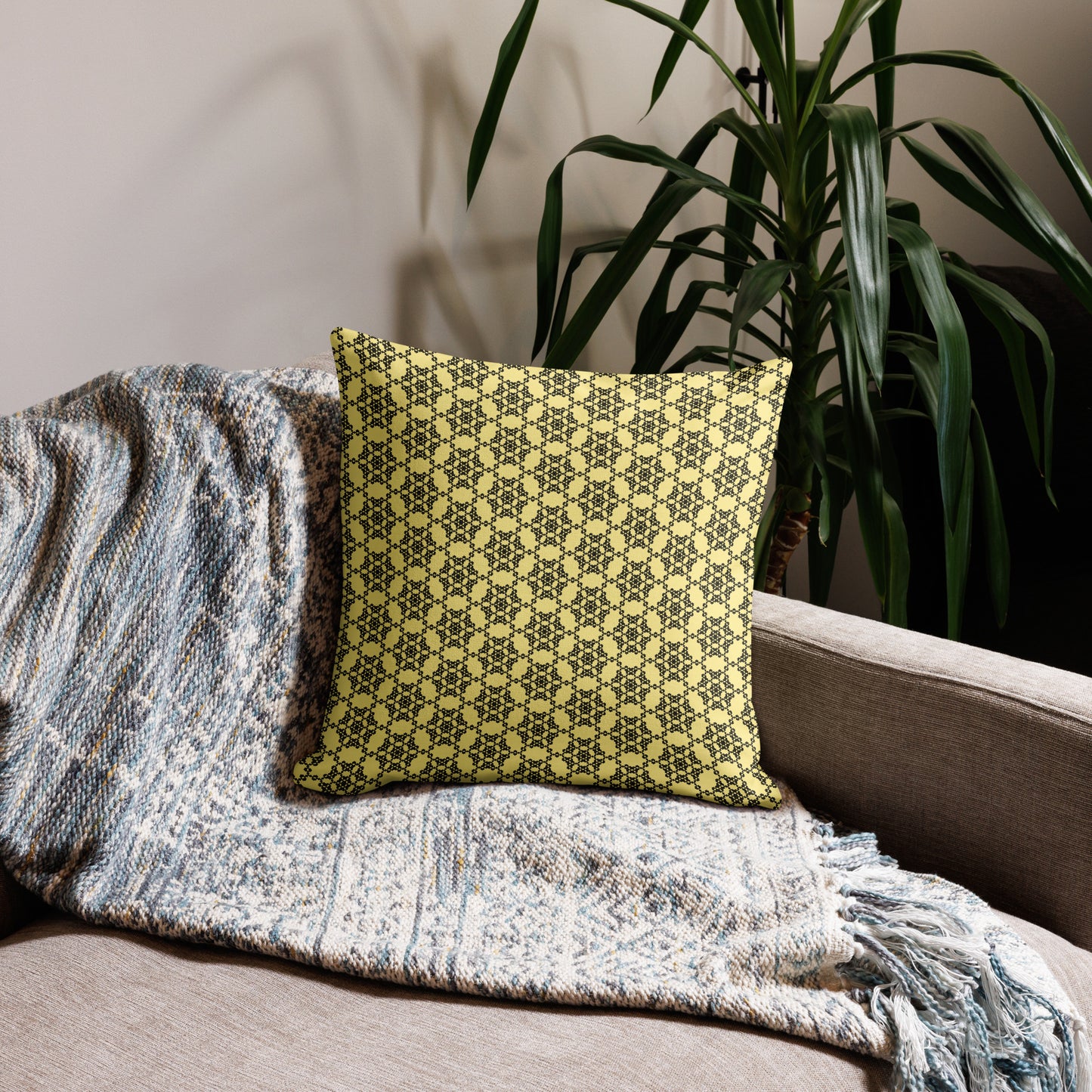 18″×18″ premium throw pillow with the 'Hexagon' yellow and black geometric pattern on a couch.