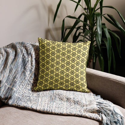 18″×18″ premium throw pillow with the 'Hexagon' yellow and black geometric pattern on a couch.