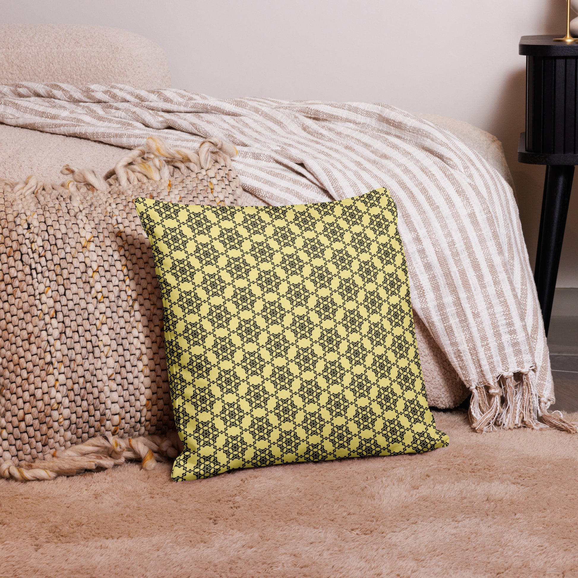 18″×18″ premium throw pillow with the 'Hexagon' yellow and black geometric pattern on a couch.