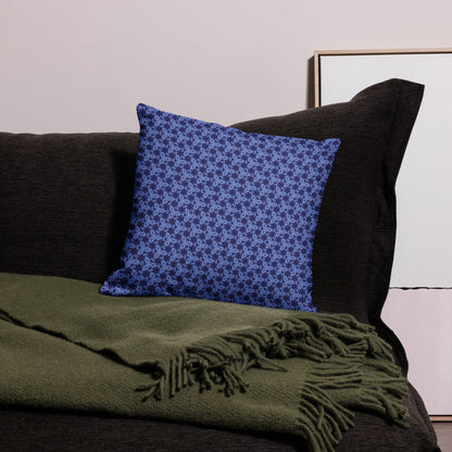 18″×18″ premium throw pillow with the 'Trigon' navy and blue geometric pattern on a couch.