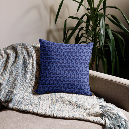 18″×18″ premium throw pillow with the 'Trigon' navy and blue geometric pattern on a couch.