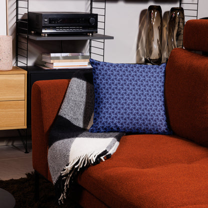 18″×18″ premium throw pillow with the 'Trigon' navy and blue geometric pattern on a couch.