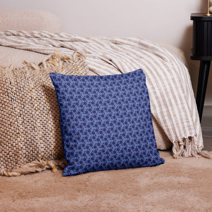 18″×18″ premium throw pillow with the 'Trigon' navy and blue geometric pattern on a couch.