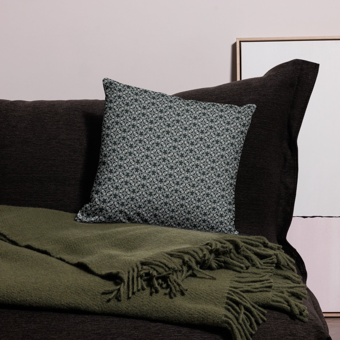 18″×18″ premium throw pillow with the 'Tetragon' charcoal and white geometric pattern on a couch.