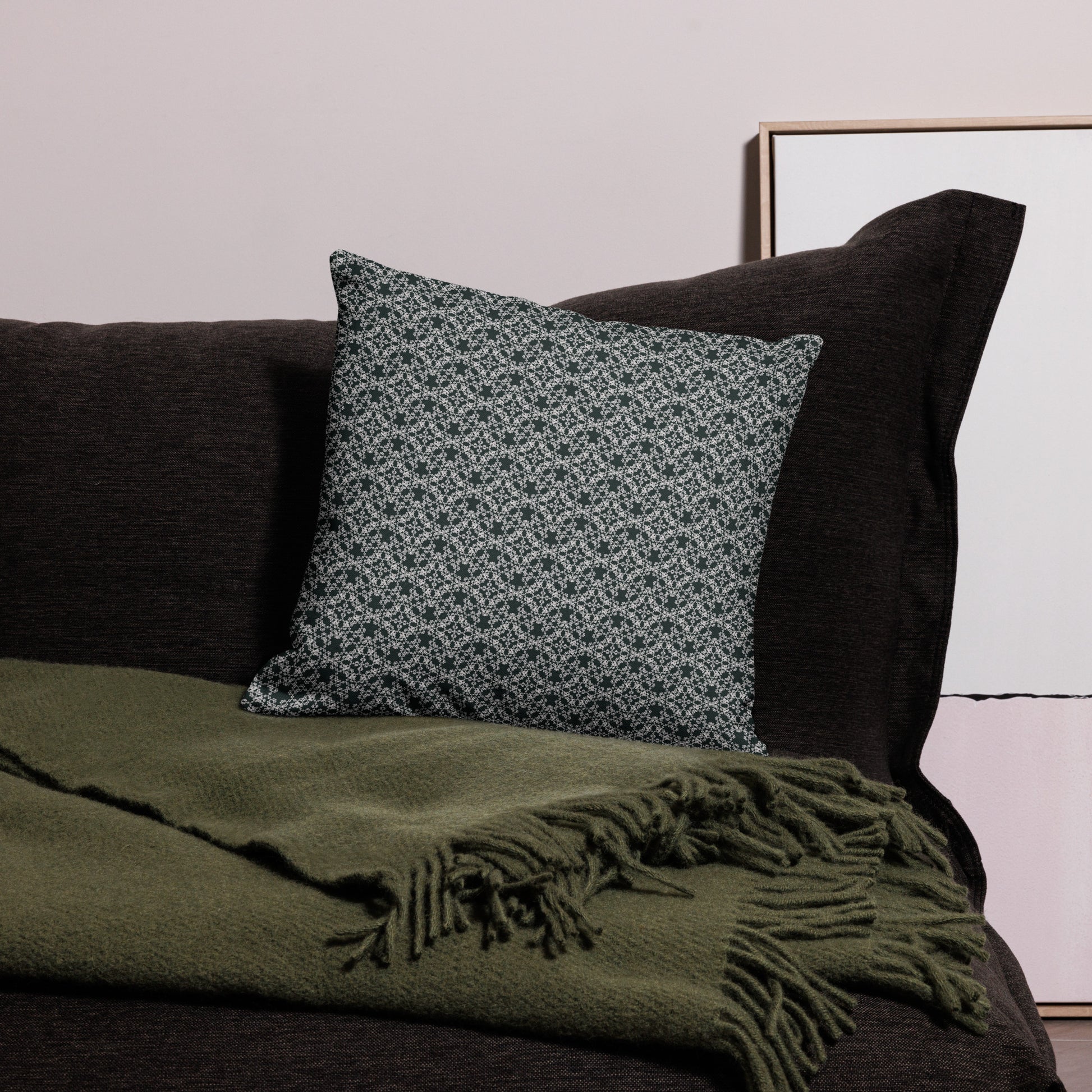 18″×18″ premium throw pillow with the 'Tetragon' charcoal and white geometric pattern on a couch.