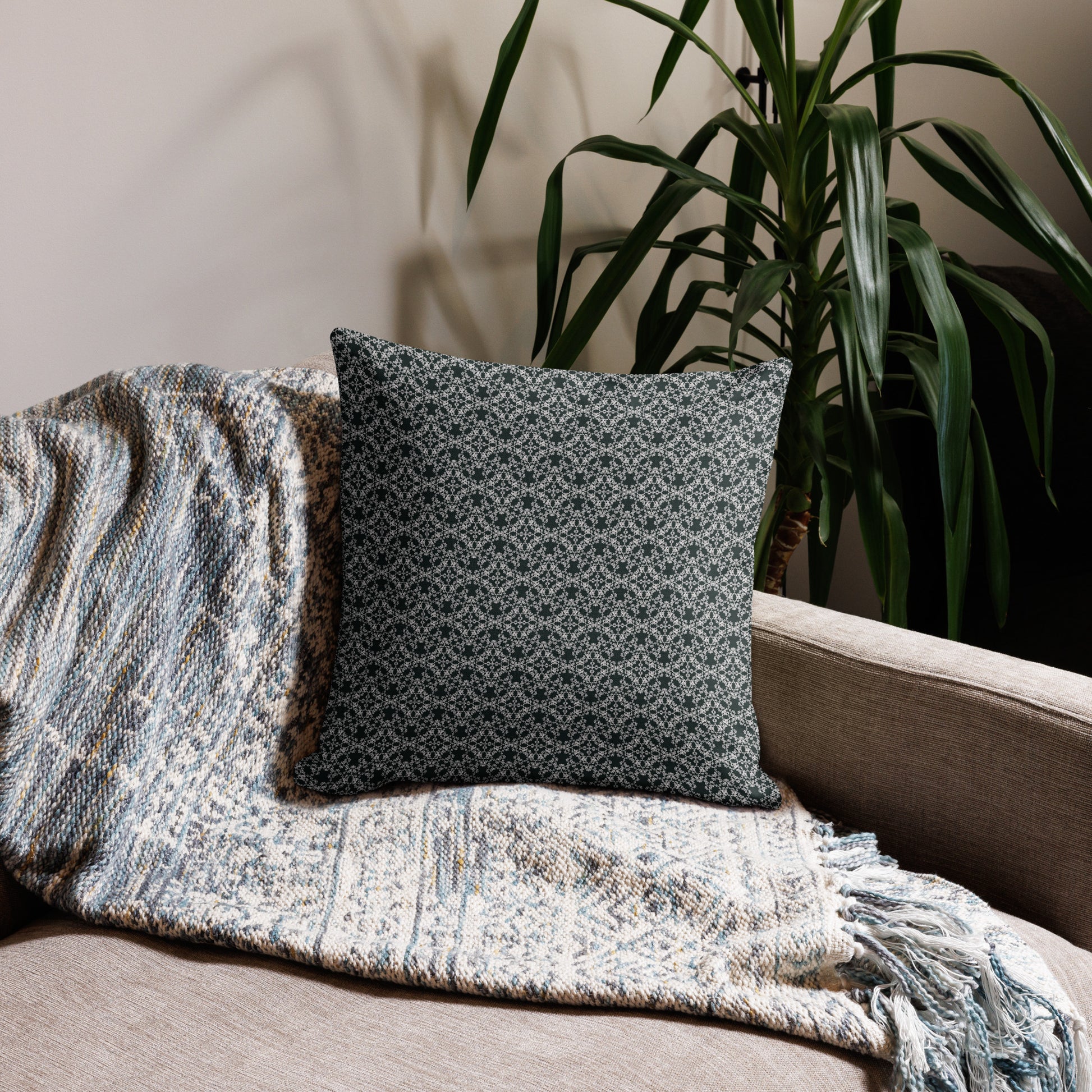 18″×18″ premium throw pillow with the 'Tetragon' charcoal and white geometric pattern on a couch.