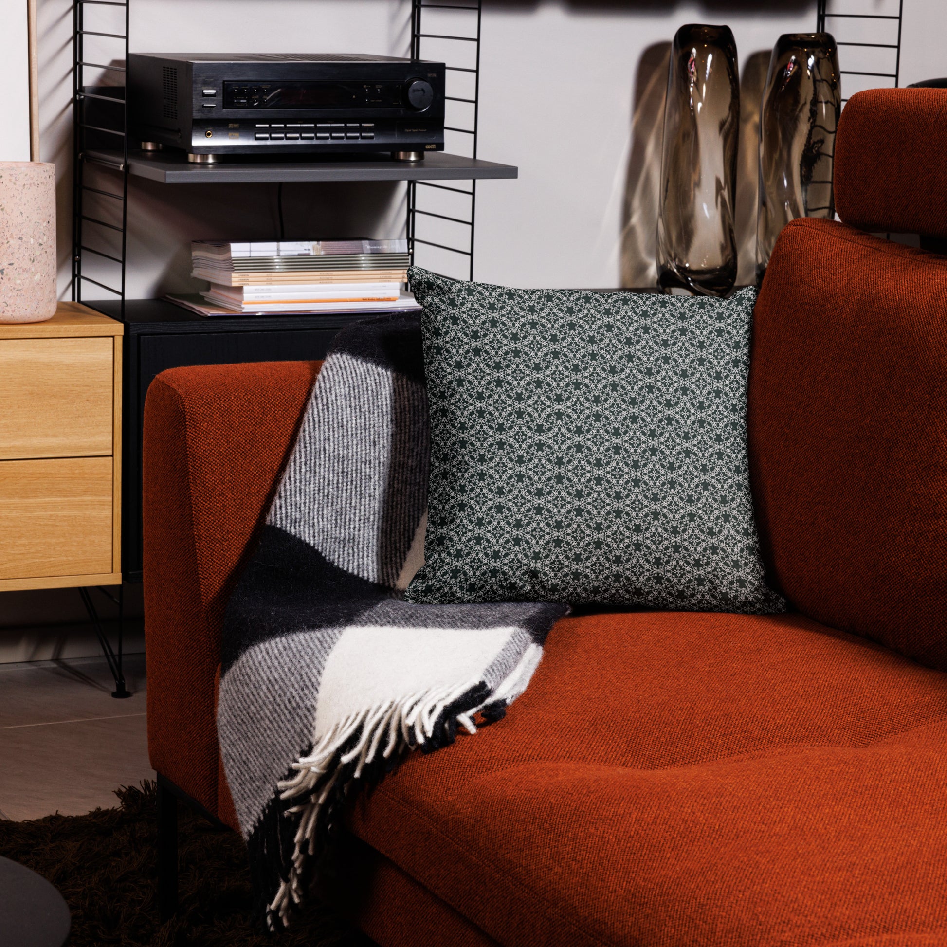 18″×18″ premium throw pillow with the 'Tetragon' charcoal and white geometric pattern on a couch.