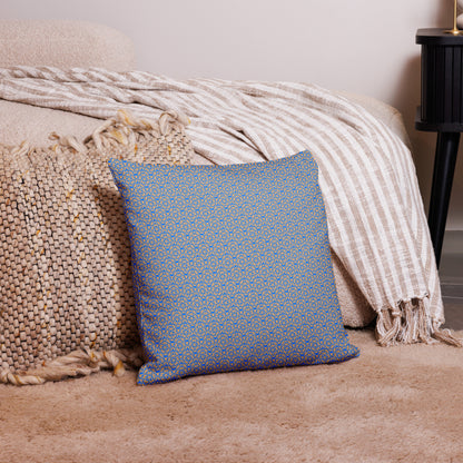 18″×18″ premium throw pillow with the 'Pentagon' blue and yellow geometric pattern on a couch.