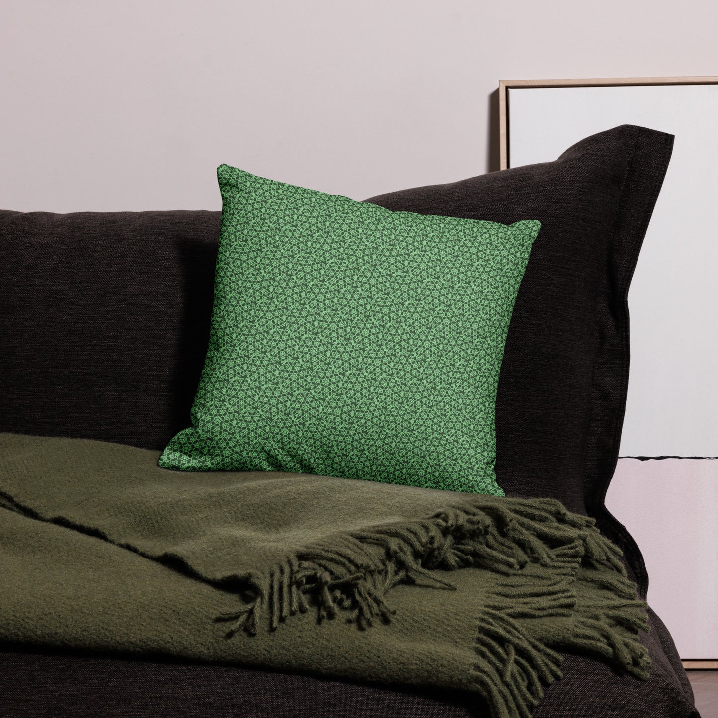 18″×18″ premium throw pillow with the 'Heptagon' green geometric pattern on a couch.