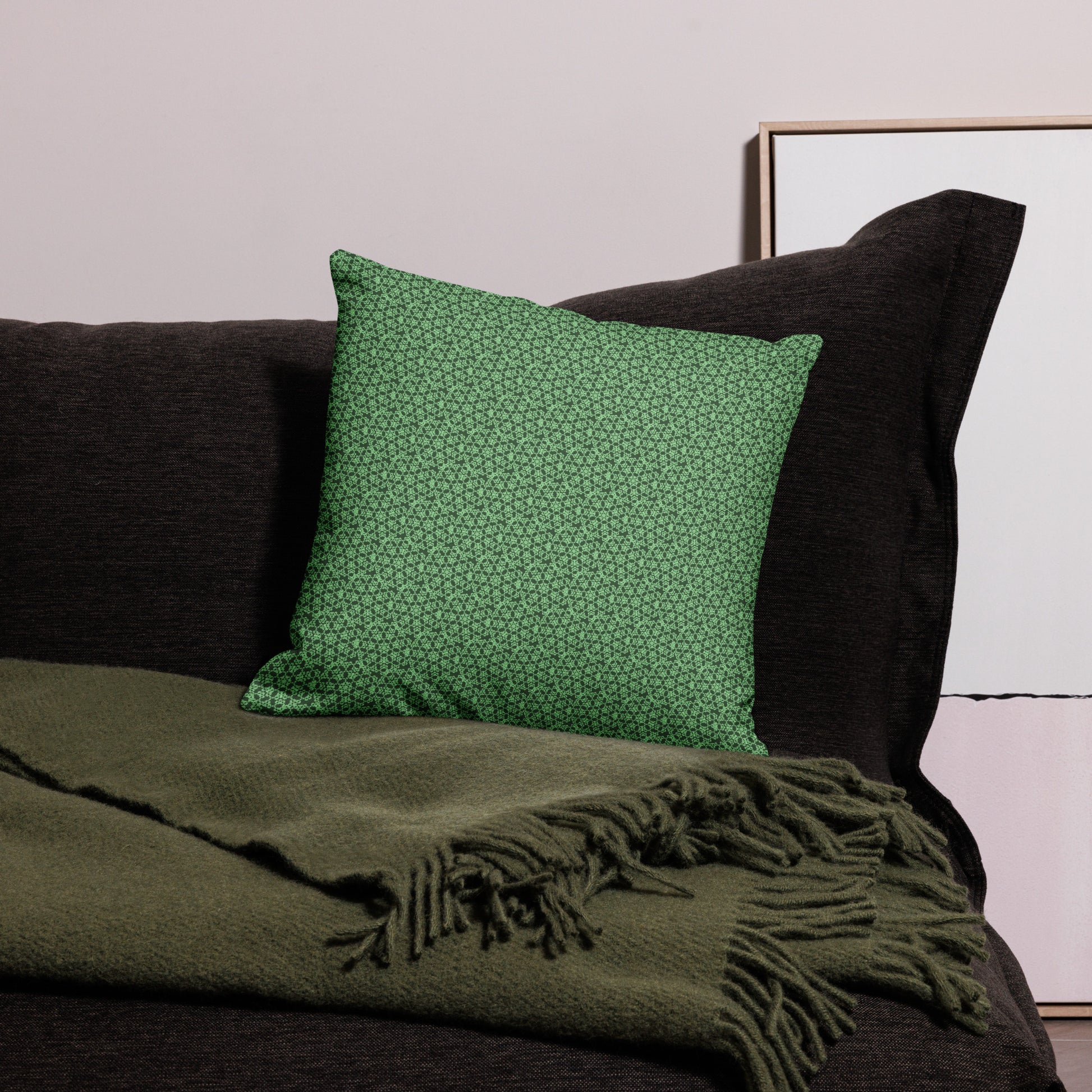 18″×18″ premium throw pillow with the 'Heptagon' green geometric pattern on a couch.