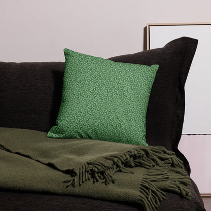 18″×18″ premium throw pillow with the 'Heptagon' green geometric pattern on a couch.