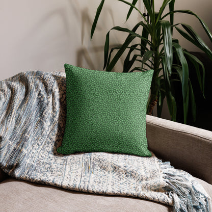 18″×18″ premium throw pillow with the 'Heptagon' green geometric pattern on a couch.