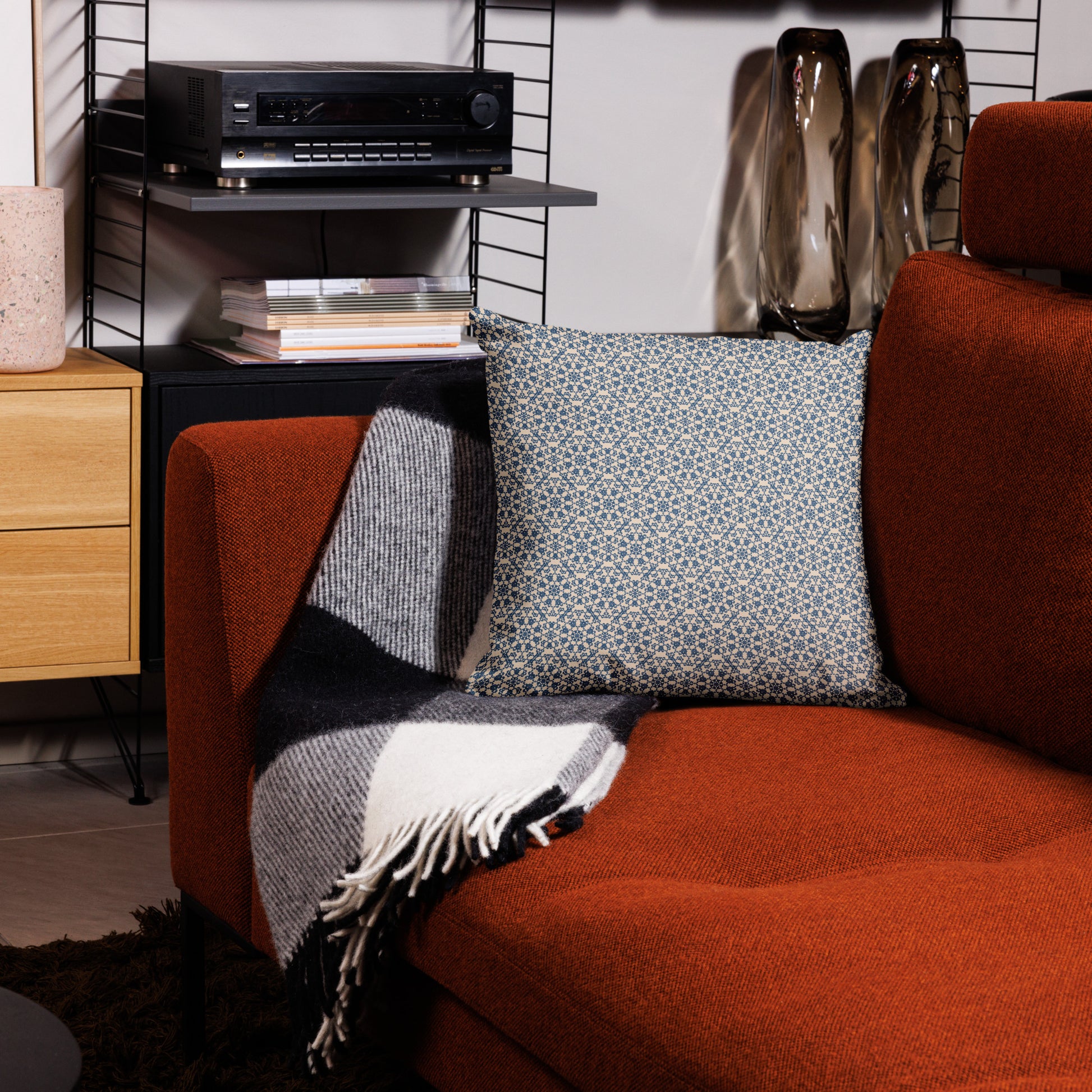 18″×18″ premium throw pillow with the ‘Octagon’ navy and beige geometric pattern on an armchair.