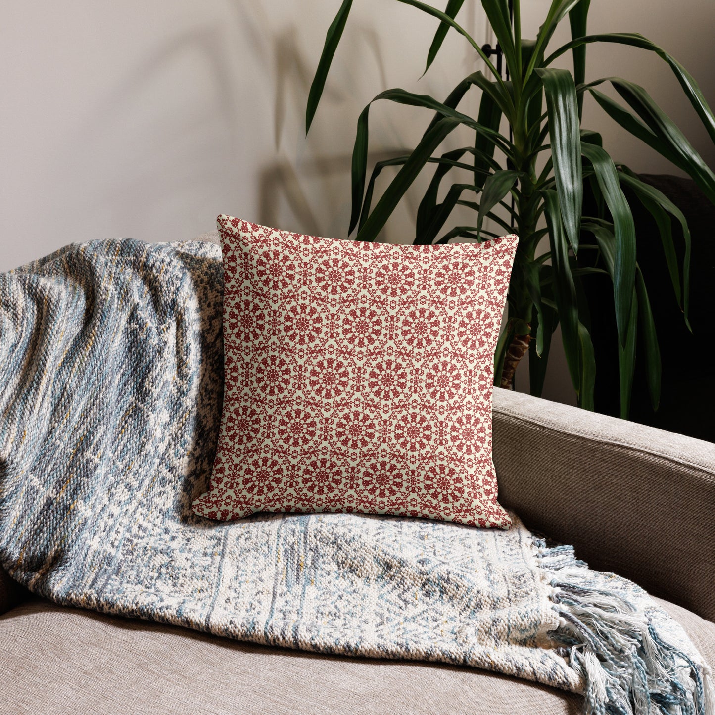 18″×18″ premium throw pillow with the ‘Decagon’ terracotta and beige geometric pattern on a beige sofa with a woven throw.