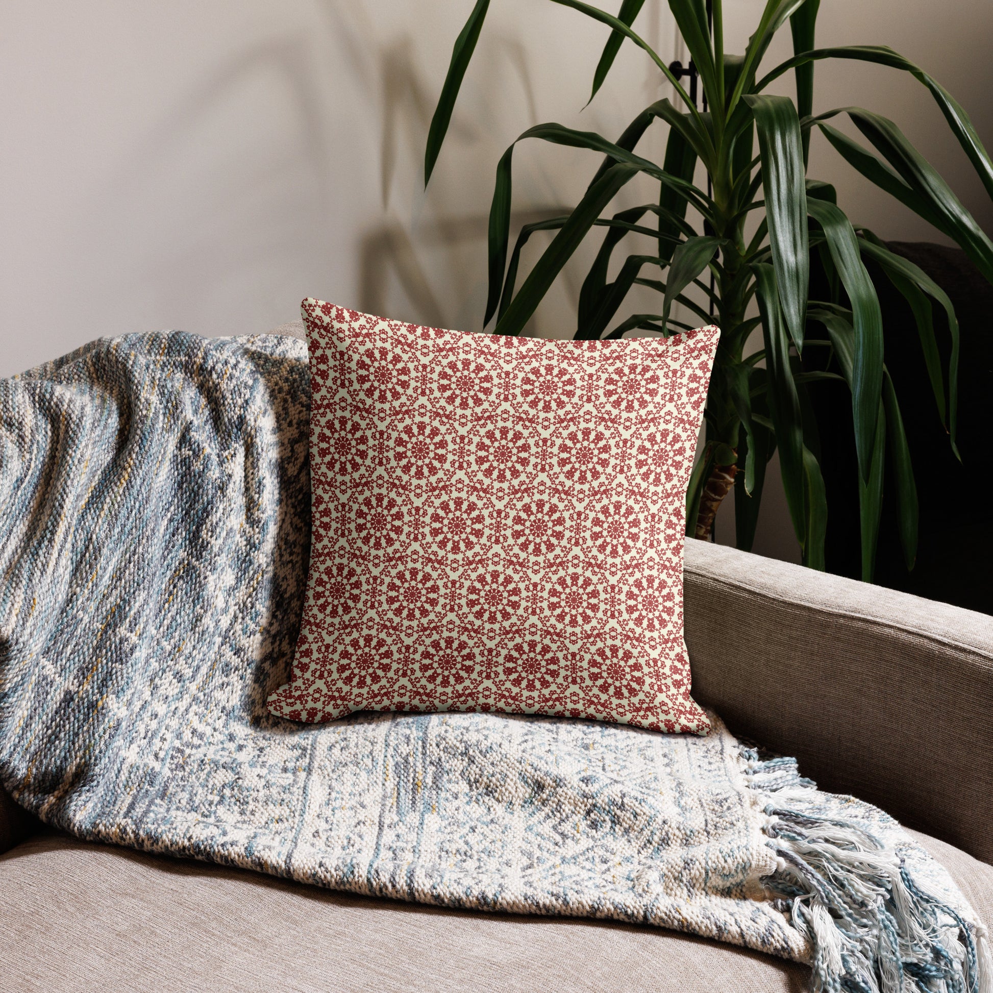 18″×18″ premium throw pillow with the ‘Decagon’ terracotta and beige geometric pattern on a beige sofa with a woven throw.